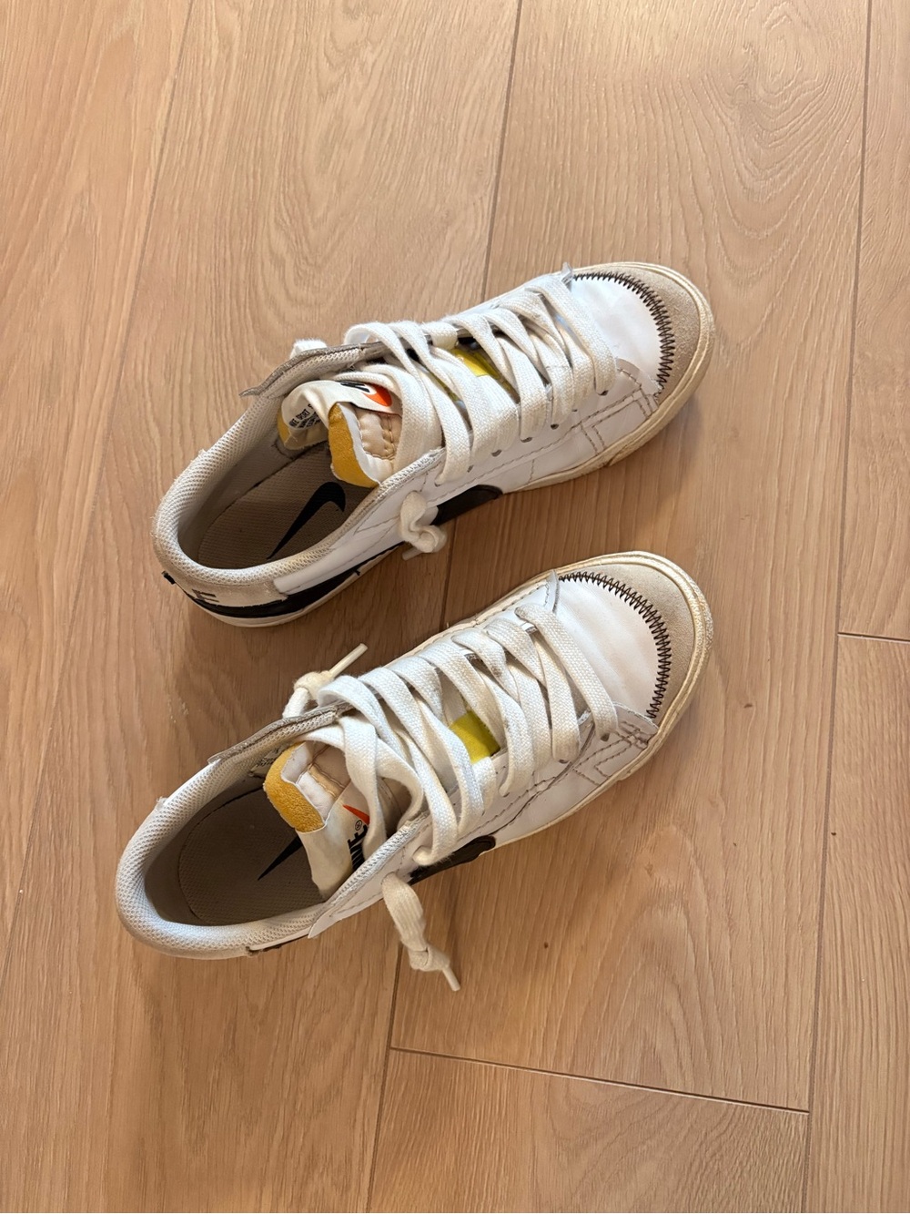 Nike White Sneakers with Black Swoosh and Yellow Accent